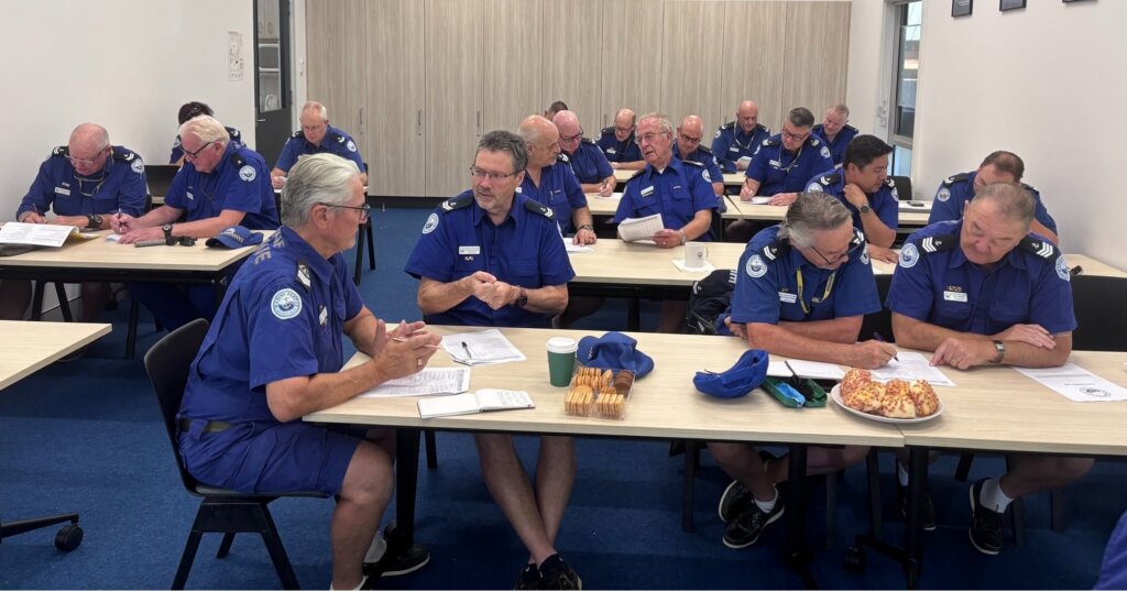 People gathered around a table during a theory session at Marine Rescue – promoting our in‑base NSW Boat Driving Licence course and online exam
